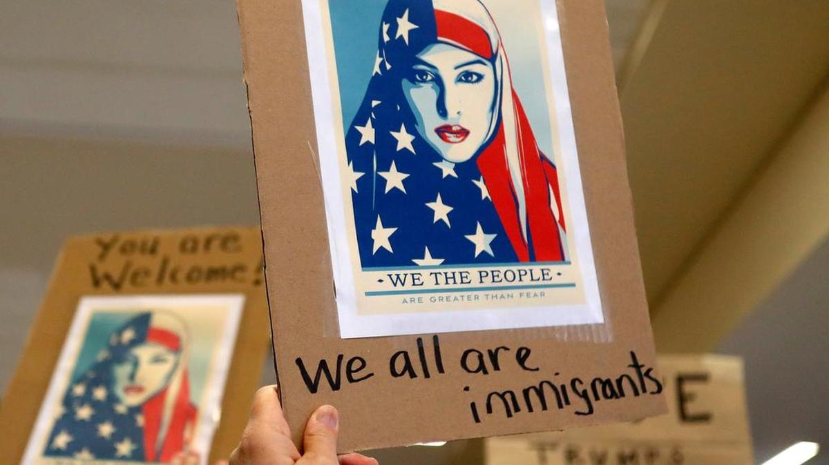 Protesters showed support Sunday for travel detainees held at DFW Airport due to President Trump’s immigration order.