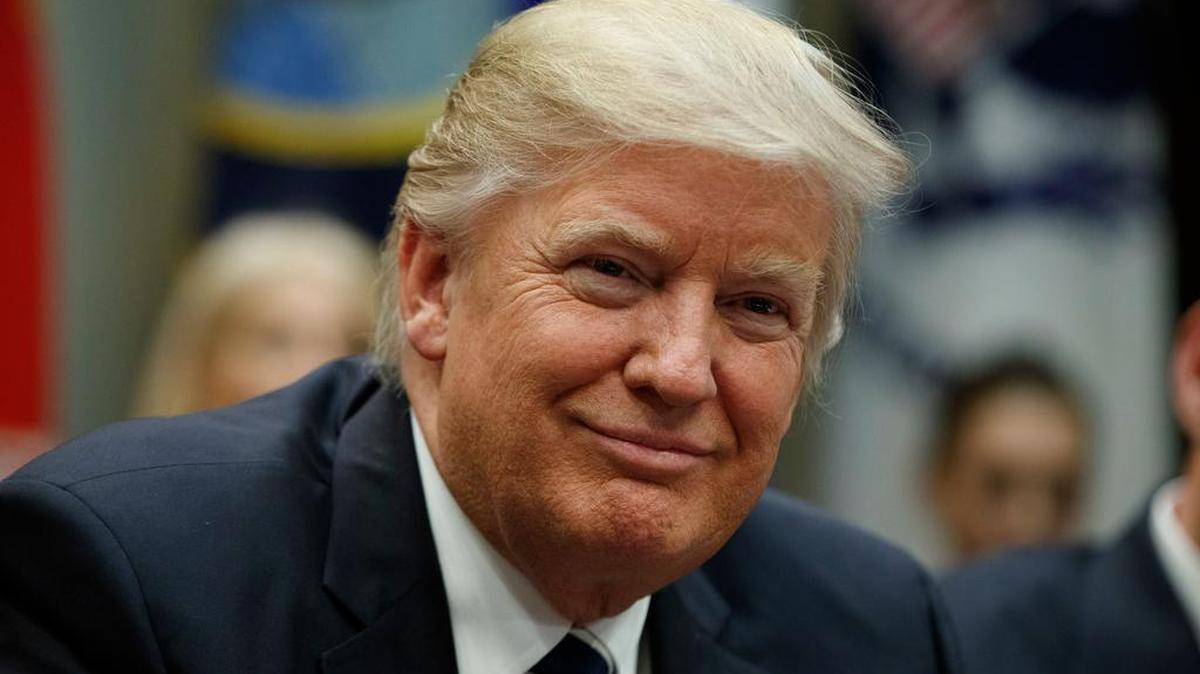 President Donald Trump watches Tuesday during a meeting on cyber security in the Roosevelt Room of the White House in Washington.