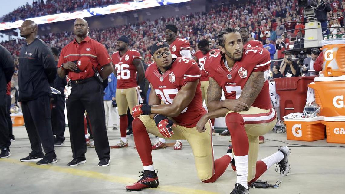Eric Reid and Colin Kaepernick kneel during the national anthem before a game against the Los Angeles Rams in Santa Clara, Calif., in 2016.