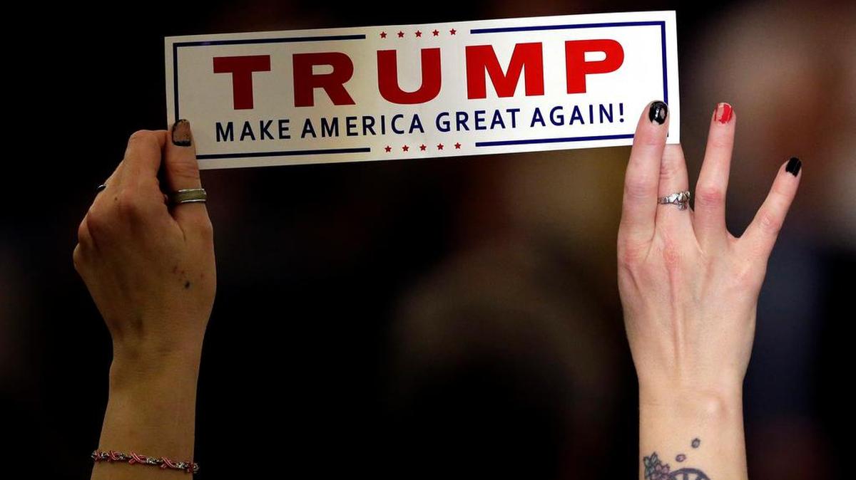 A supporter holds a sign while Republican presidential candidate Donald Trump speaks during a campaign stop, Wednesday, March 30, 2016, in Appleton, Wis.