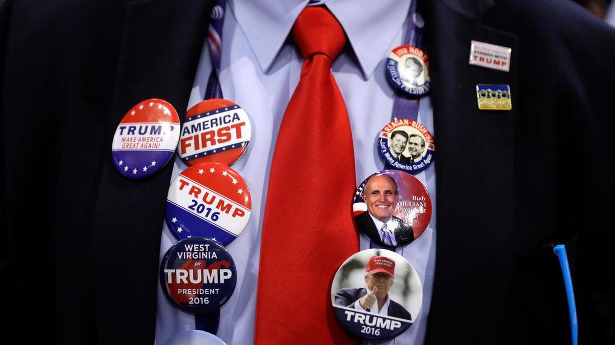 Caleb Turner from Hurricane, W.Va., shows off his button collections during first day of the Republican National Convention in Cleveland, Monday, July 18, 2016.