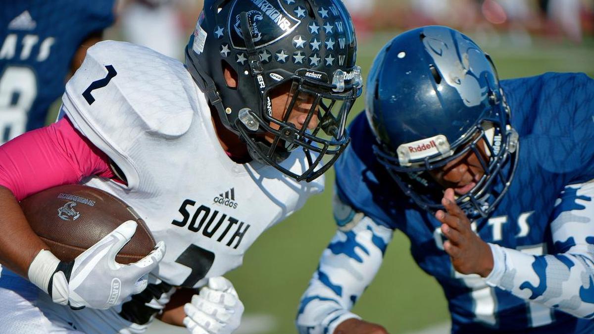 South Hills Scorpions Tylan Wallace (2) bang for extra yards as YMLA Deuante Hartin (11) makes the stop as South Hills plays Young Men's Leadership Academy at Clark stadium in Fort Worth, TX, Saturday, Oct. 22, 2016.