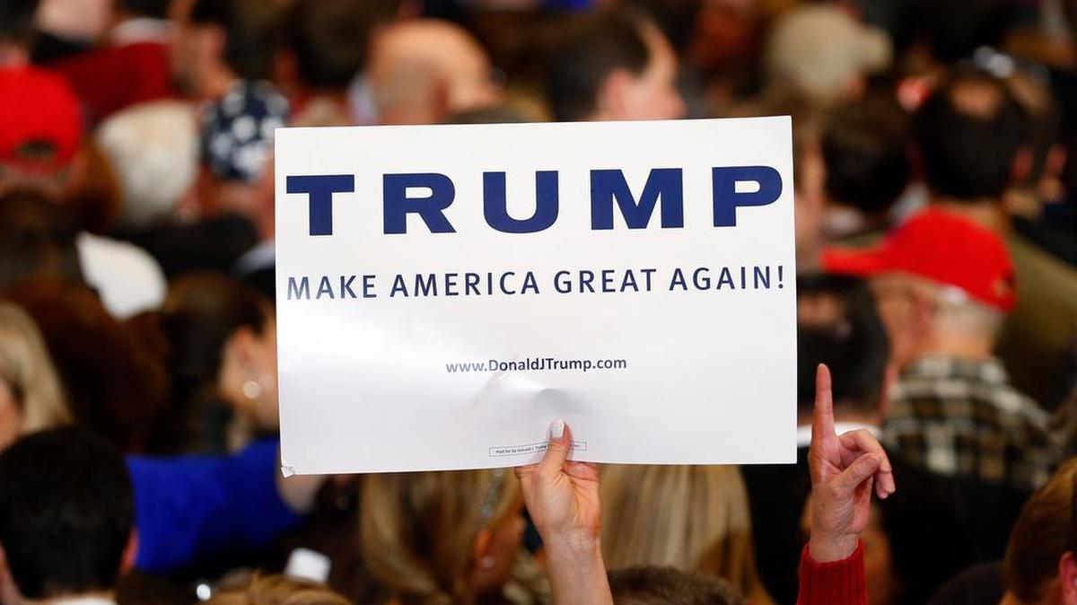 A supporter holds up a sign for Republican presidential candidate Donald Trump during a South Carolina Republican primary night event, Saturday, Feb. 20, 2016 in Spartanburg, S.C.