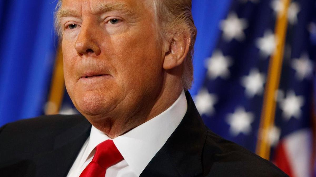 President-elect Donald Trump listens to a question during a news conference Wednesday in the lobby of Trump Tower in New York.