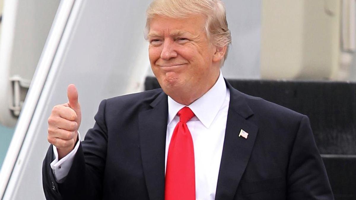 President Donald Trump gestures as he walks down the stairs of Air Force One March 3 upon his arrival at Palm Beach International Airport in West Palm Beach, Fla.