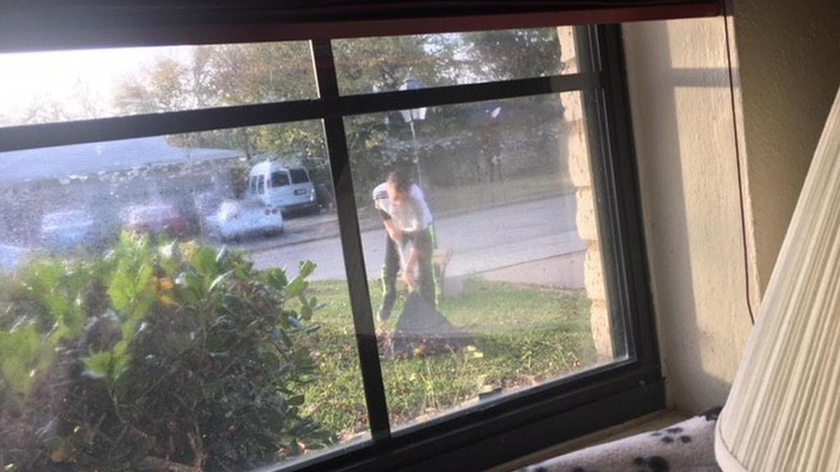 Holiday Helper Juan raking his neighbor’s leaves.