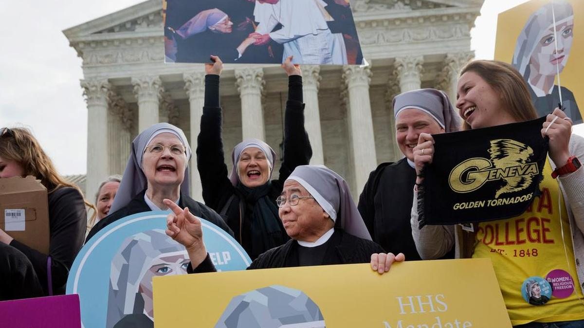 Nuns with the Little Sisters of The Poor, including Sister Celestine, left, and Sister Jeanne Veronique, center, rally outside the Supreme Court in Washington, Wednesday, March 23, 2016, as the court hears arguments to allow birth control in healthcare plans in the Zubik vs. Burwell case.