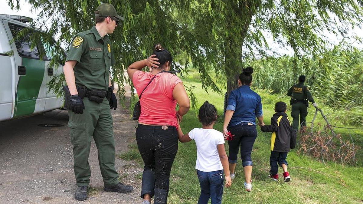A group of migrants are apprehended by Border Patrol agents after crossing the Rio Grande in Eagle Pass, Texas, on May 24.