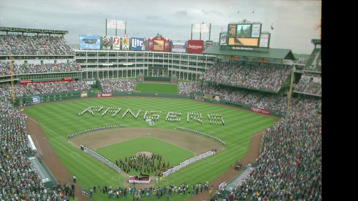 
Texas Rangers fans stand in 1994 as the late Van Cliburn joins the Fort Worth Symphony to play the national anthem and open what was then named the Ballpark in Arlington. 
