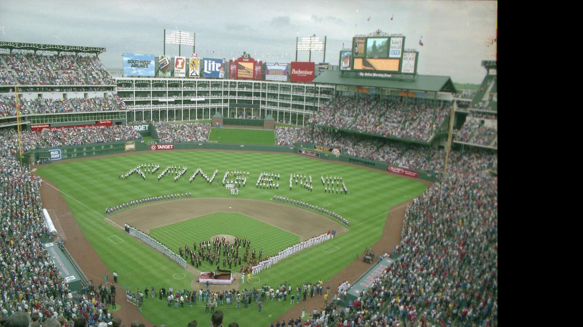 
Texas Rangers fans stand in 1994 as the late Van Cliburn joins the Fort Worth Symphony to play the national anthem and open what was then named the Ballpark in Arlington. 
