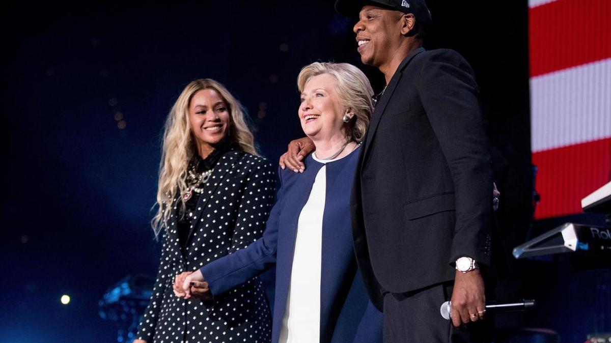 Democratic presidential candidate Hillary Clinton, center, appears with artists Beyonce, left, and Jay Z, right, Nov. 4.