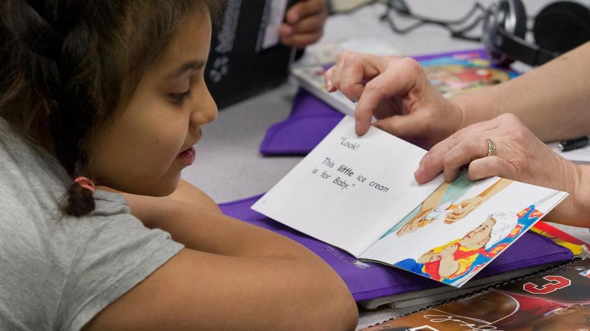 Evelyn Estrada gets some individual help in her classroom at Wimbish Elementary in Arlington.