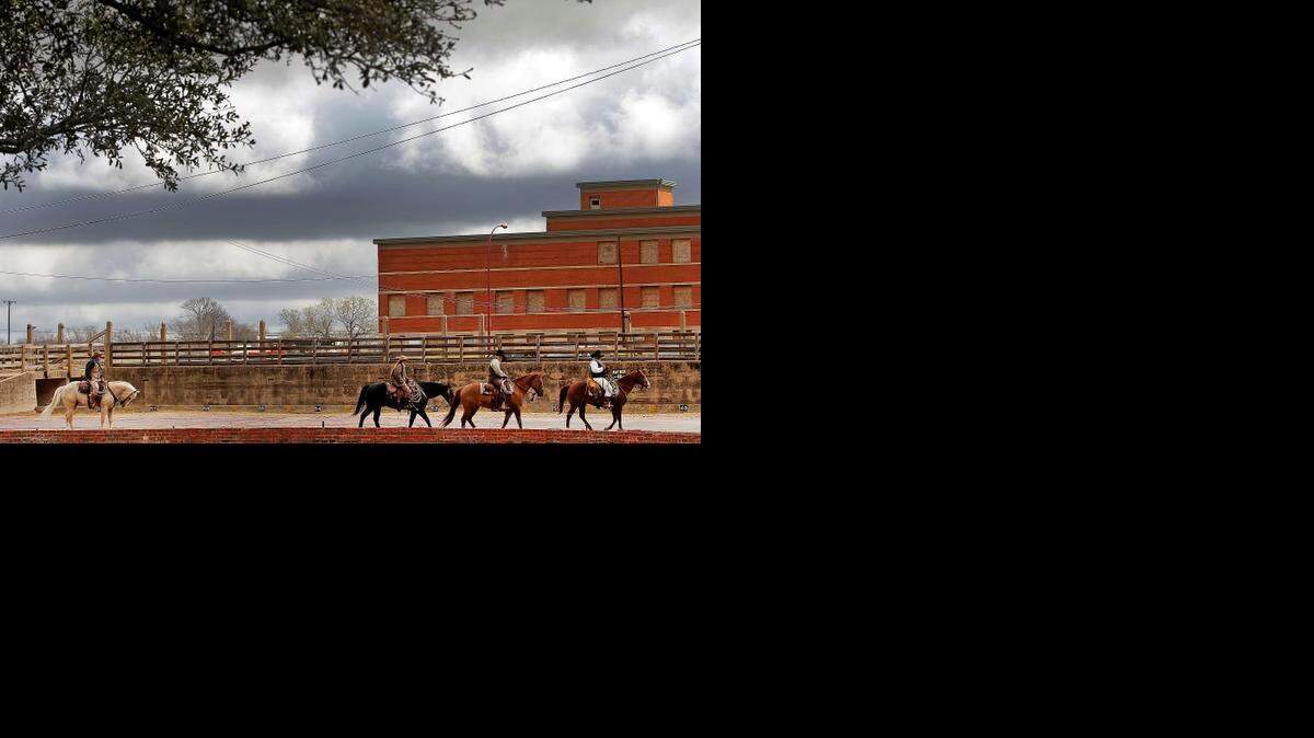 
Cowboys ride after escorting longhorns in the Fort Worth Stockyards. 
