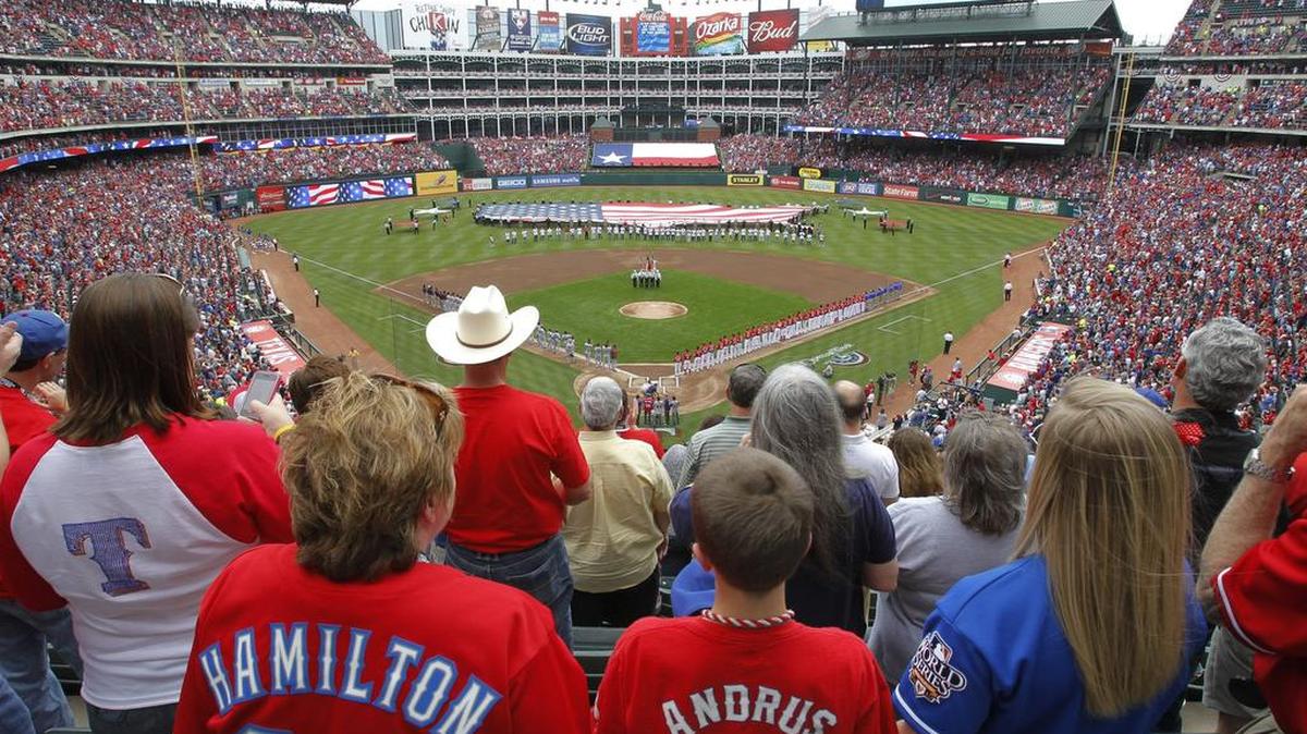 Fans stand for the National Anthem during opening day of the 2011 season at the Rangers Ballpark in Arlington, Friday, April, 1, 2011, as the Texas Rangers play the Boston Red Sox.