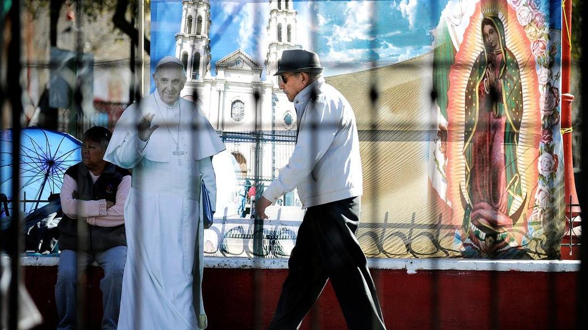 A pedestrian walks by a cutout Pope Francis in front of Nuestra senora de Guadalupe church in Ciudad Juarez, Chihuahua, Tuesday.