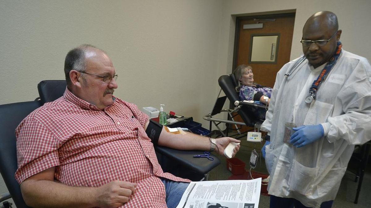 Anthony Gowan of Crowley donates blood as Drew Gaddy of the Red Cross takes the donation at Turning Point Church in Fort Worth on July 23, 2014.