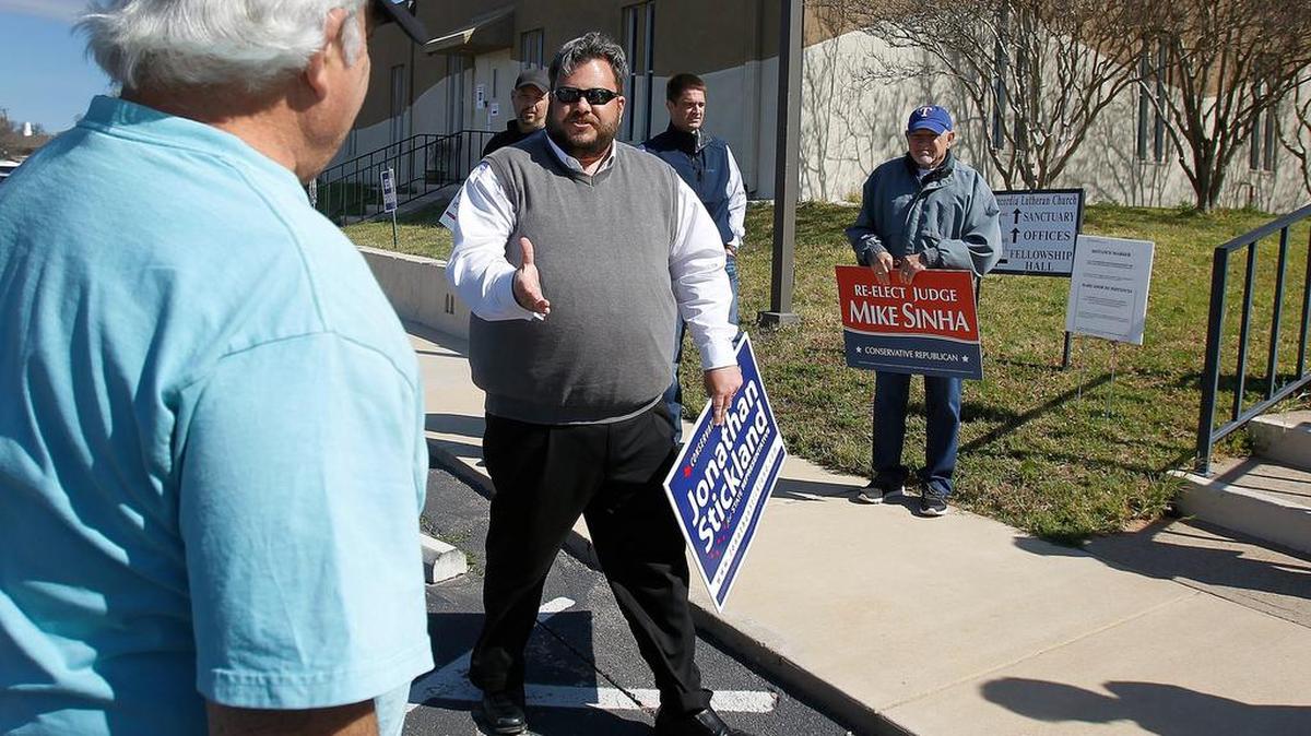 Jonathan Stickland reaches out to voters at a polling station at Concordia Lutheran Church in Bedford on Tuesday, March 1, 2016.