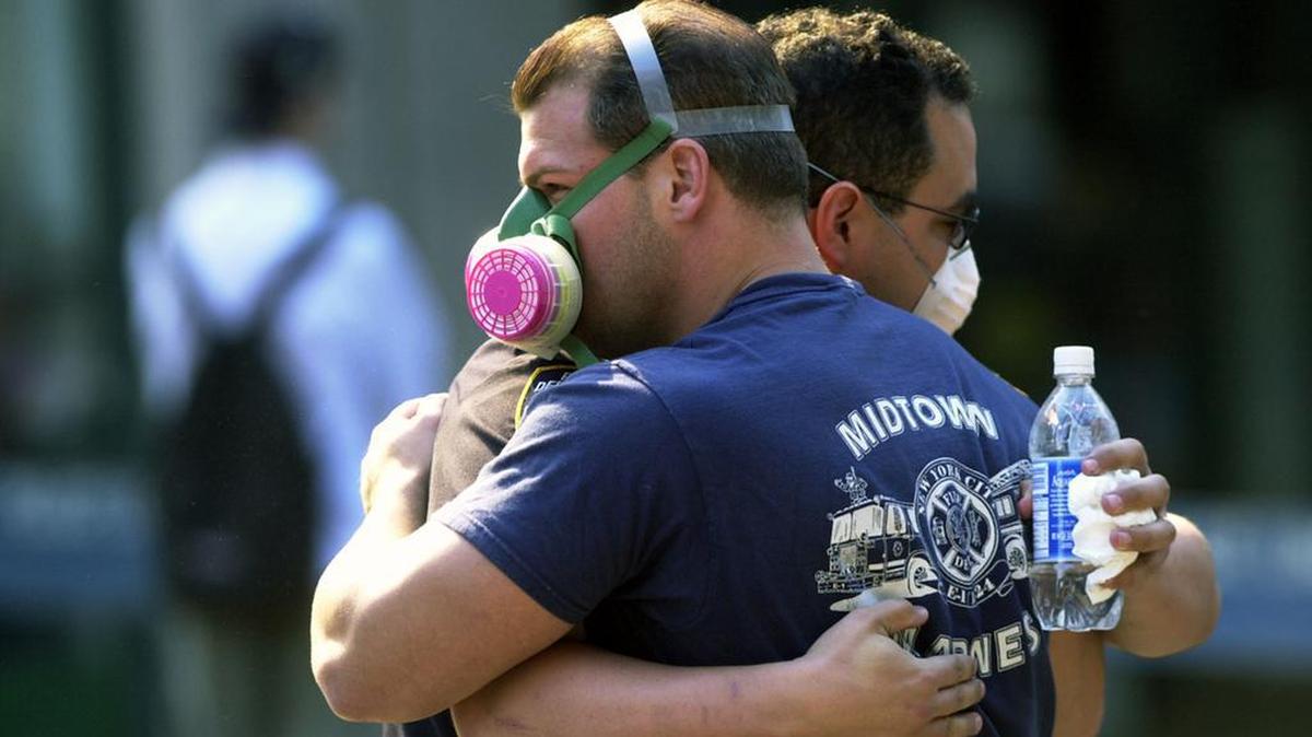 Two ground zero emergency workers hug on Sept. 13, 2001 after the September 11 terrorist attacks on the World Trade Center in New York City.