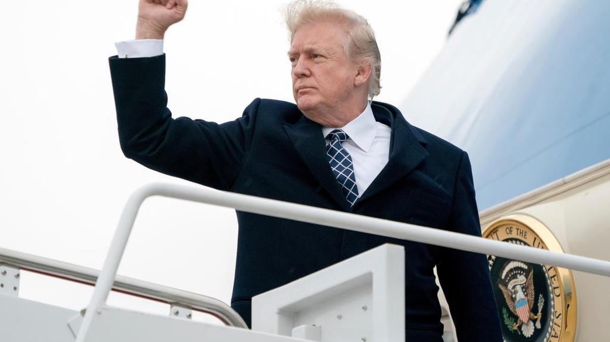 President Donald Trump gestures as he boards Air Force One at Andrews Air Force Base, Md., Friday, Jan. 12, 2018, to travel to Palm Beach International Airport in West Palm Beach, Fla.