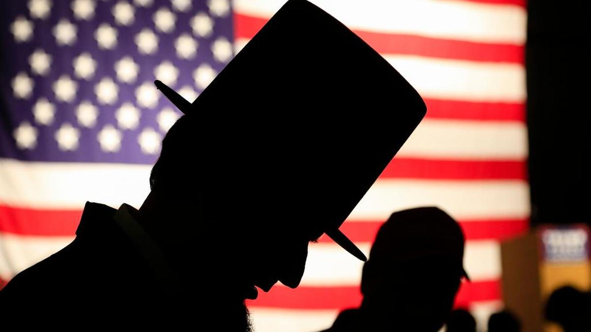 James Mitchell, an Abraham Lincoln look-alike, interacts with members of the audience before an election rally by Republican vice presidential candidate Indiana Gov. Mike Pence, in Council Bluffs, Iowa, Monday, Aug. 8, 2016.