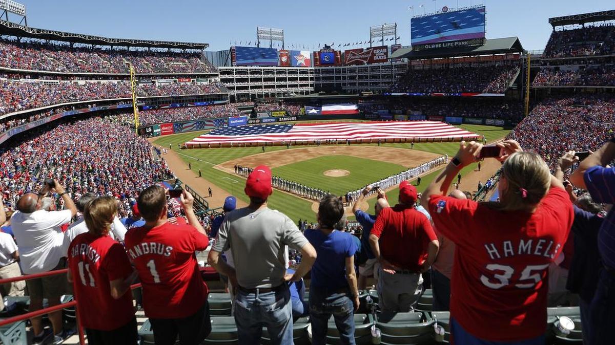 Fans rise for the National Anthem April 4 in the 2016 season opener in Globe Life Park.
