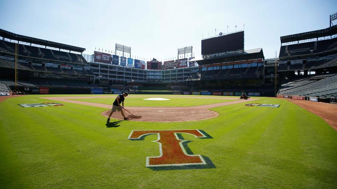 A Texas Rangers grounds crew member prepares the field before the Rangers team workout, Saturday, October 10, 2015, at Globe Life Park in Arlington, Texas.