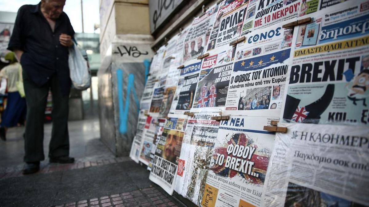 A man browses through newspapers outside a kiosk in Athens, on Saturday, June 25, 2016. Britain and the EU haven't even begun divorce talks but they are already bickering, as political and economic shockwaves from the British vote spread around the world.