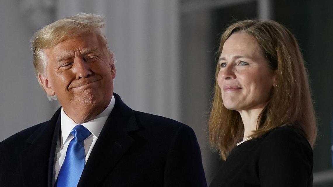 President Donald Trump and Amy Coney Barrett stand on the Blue Room Balcony after Supreme Court Justice Clarence Thomas administered the Constitutional Oath to her on the South Lawn of the White House White House in Washington, Monday, Oct. 26, 2020. Barrett was confirmed to be a Supreme Court justice by the Senate earlier in the evening. (AP Photo/Patrick Semansky)