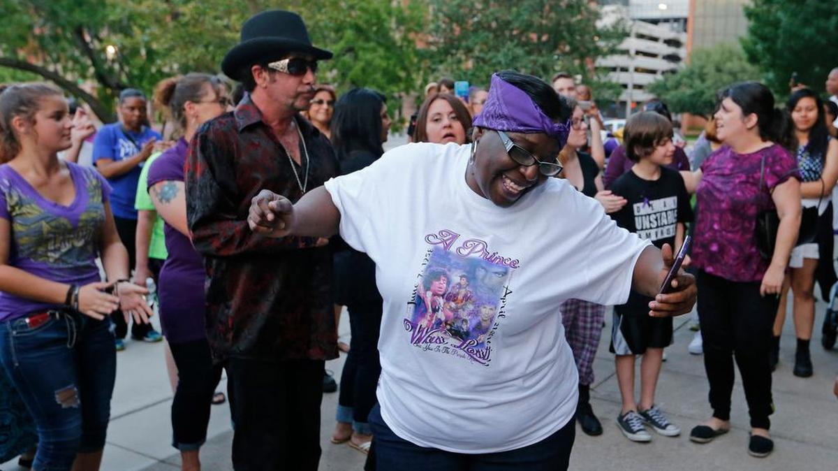 Kaye Smith dances to a Prince song during a memorial celebration to remember Prince at the Tarrant County Courthouse, Monday, April 25, 2016.