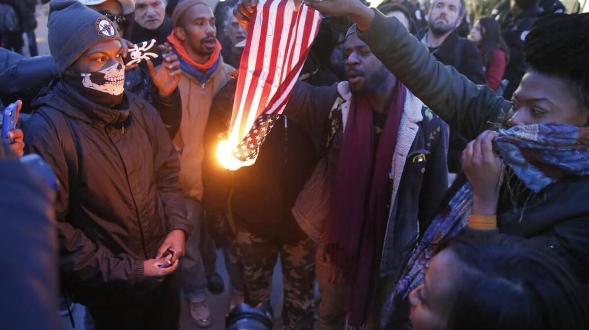 Protesters burn an American flag in Chicago.