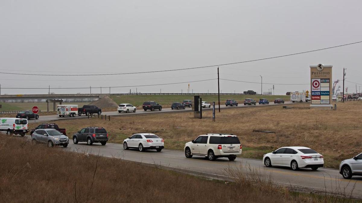 Traffic backs up looking north from North Tarrant Parkway at U.S. 287 toward Harmon Road, west end of the Presidio Junction shopping area in Fort Worth.