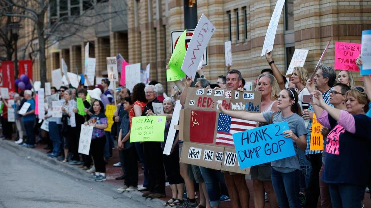 Demonstrators protest Saturday outside of the Tarrant County Republican Lincoln Day Dinner at the Omni Hotel in Fort Worth.