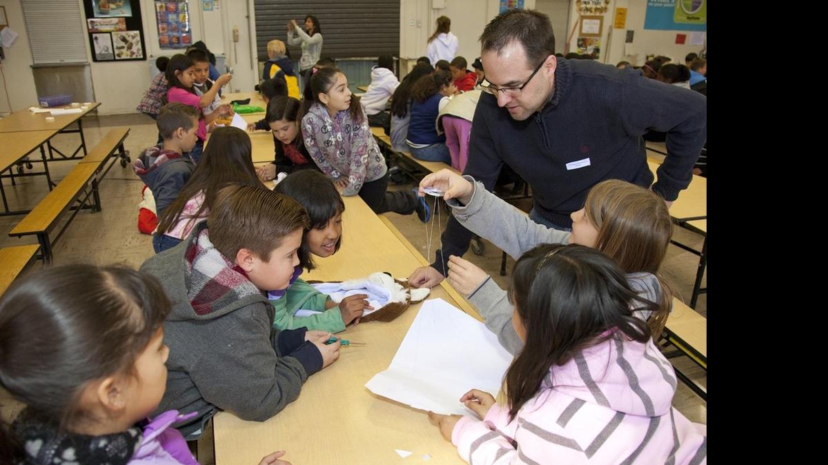 
Students study a classroom project. 
