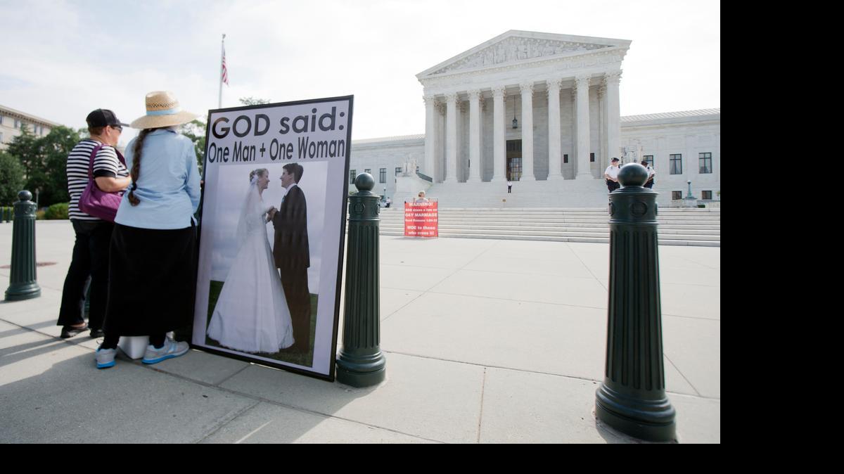 
Protesters at the Supreme Court await the court’s ruling on same-sex marriage. 
