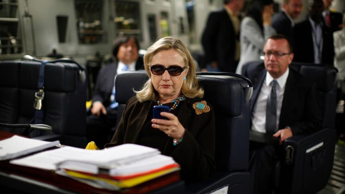 The potential 2016 presidential candidate's profile page shows the infamous photo of the stern-looking Clinton wearing dark sunglasses and reading her Blackberry.