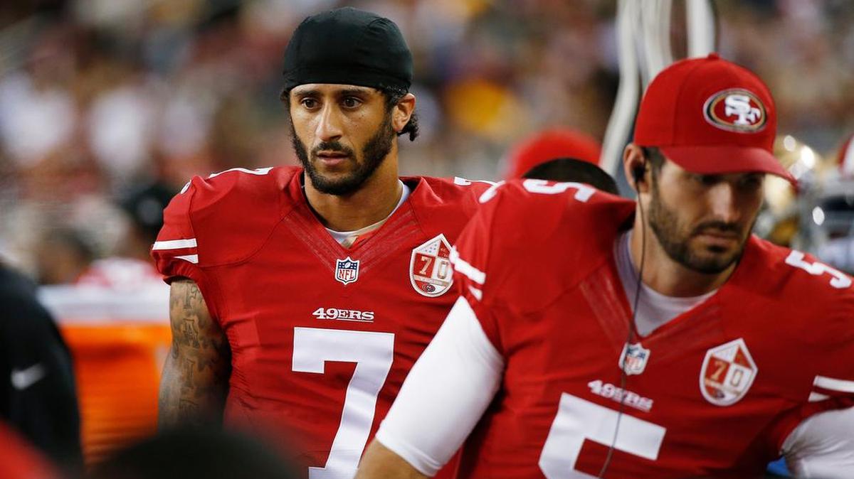 NFL player Colin Kaepernick (7) won’t stand during anthem, protests racial oppression.