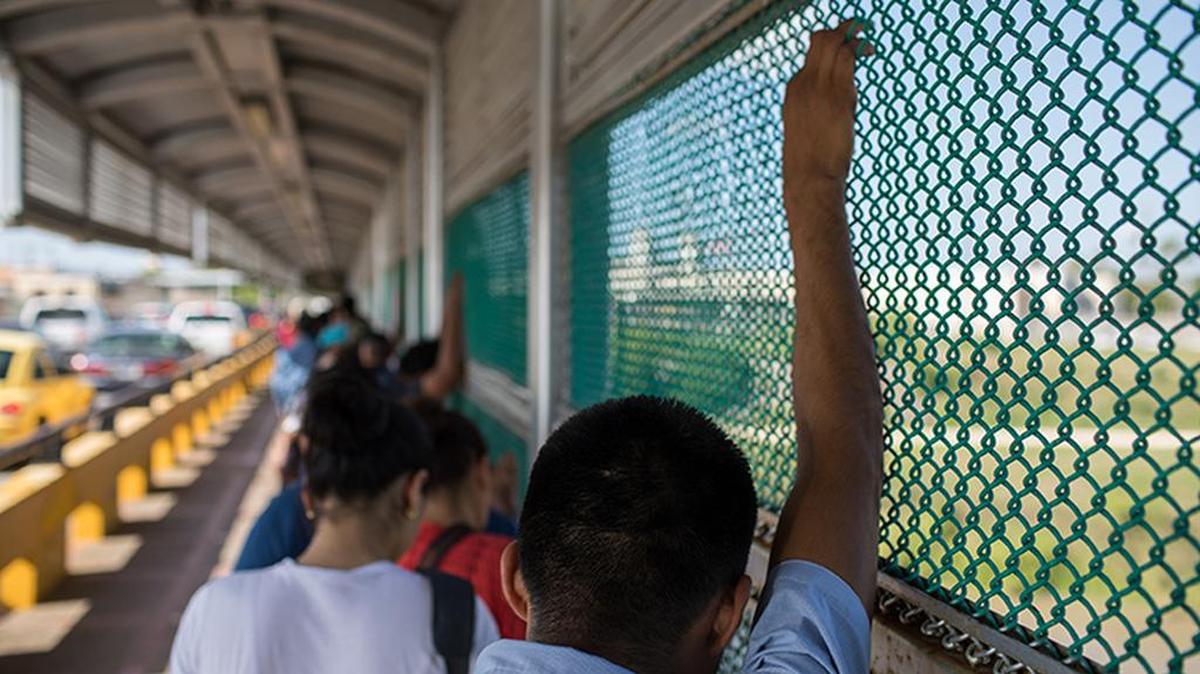 A Mexican citizen waits to legally cross from Matamoros, Mexico into Brownsville, Texas, where he planned to go shopping.