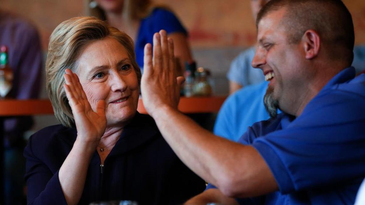 Democratic presidential candidate Hillary Clinton high-fives Scott Conley while speaking to steelworkers in Ashland, Ky., Monday, May 2, 2016.