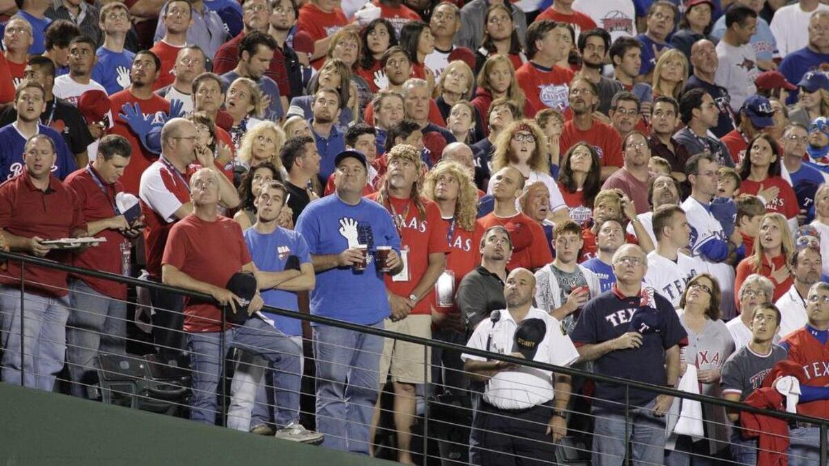 Ranger fans join in singing "God Bless America". The San Francisco Giants and the Texas Rangers play Game 4 of the Major League Baseball 2010 World Series at Rangers Ballpark in Arlington, TX., Sunday, Oct. 31, 2010.