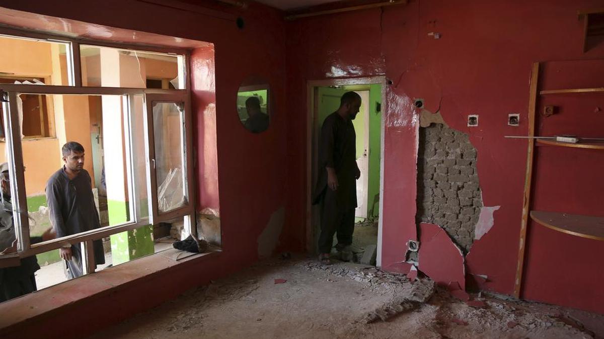 Afghans inspect their damaged house after a large explosion last week near a compound housing several foreign organizations and guesthouses, in Kabul, Afghanistan. The Taliban car bomb targeted the compound but instead shredded Afghan homes, with stunned and bloodied families picking up children and fleeing in darkness as their once-solid world collapsed.