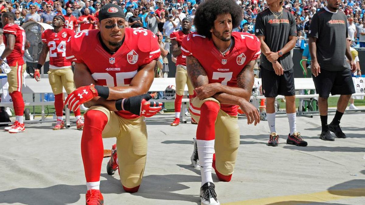 San Francisco 49ers' Colin Kaepernick (7) and Eric Reid (35) kneel during the national anthem before an NFL football game against the Carolina Panthers in Charlotte, N.C., Sunday, Sept. 18, 2016.