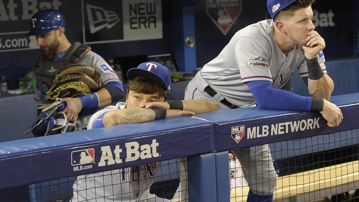 Texas Rangers catcher Jonathan Lucroy (25), right fielder Shin-Soo Choo (17) and first baseman Ryan Rua (16) soak in the loss as the Toronto Blue Jays beat 7 - 6 the Texas Rangers in 10 innings during game 3 of the ALDS at Rogers Centre in Toronto, ON, Sunday, Oct. 9, 2016.
