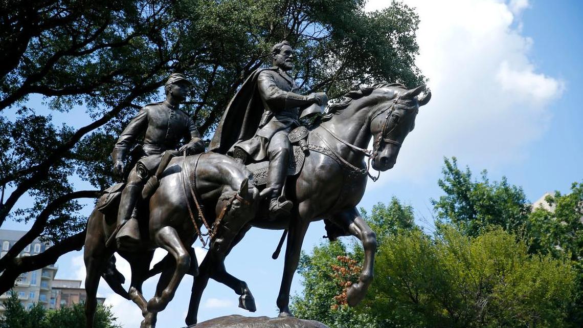 A statue honoring Robert E. Lee, right, with a soldier riding alongside him, in Robert E. Lee Park, a City of Dallas park, in the Turtle Creek area of Dallas was removed.