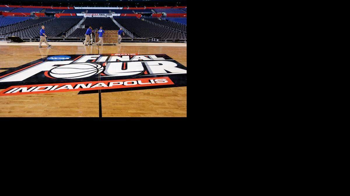 
Workers prepare the court in Indianapolis to host the men’s NCAA Final Four college basketball games Friday and Monday. 
