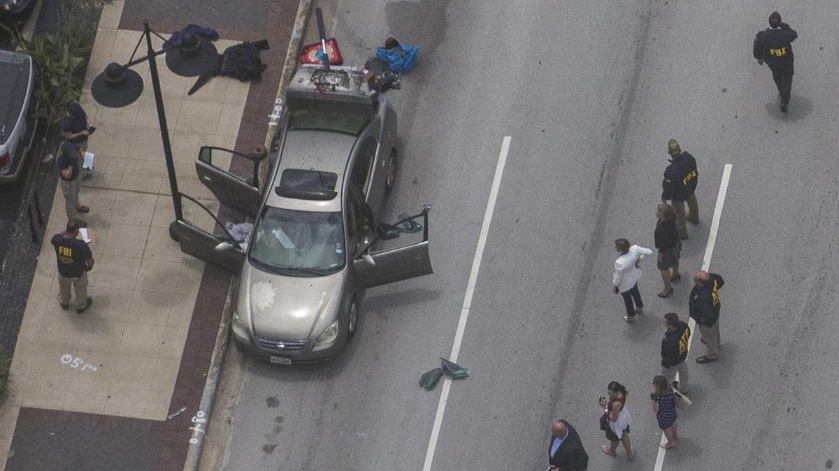 Law enforcement investigate a vehicle tied to an active shooter incident at the Earle Cabell Federal Building on Monday, June 17.
