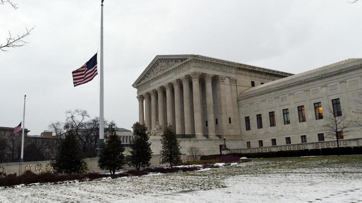 The flag flies at half-staff outside the Supreme Court in Washington on Tuesday.