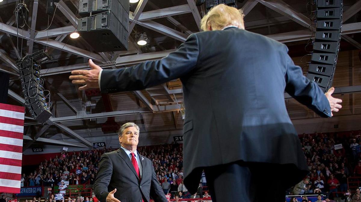 President Donald Trump greets talk show host Sean Hannity at a Make America Great Again rally in Cape Girardeau, Missouri on November 5, 2018.