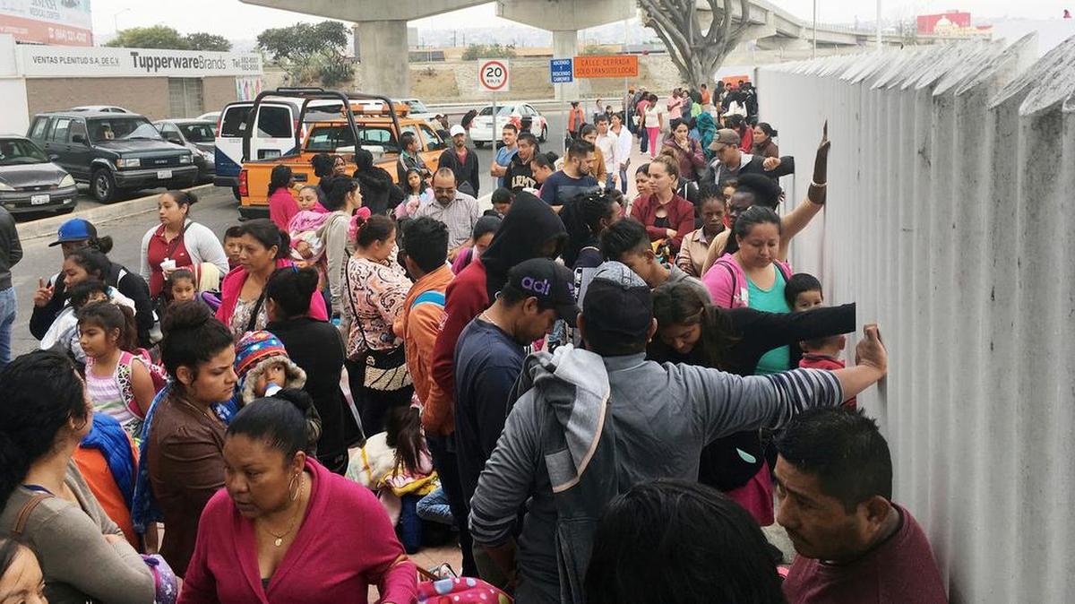 In this Monday, June 4, 2018 photo, people seeking political asylum in the United States line up to be interviewed in Tijuana, Mexico, just across the U.S. border south of San Diego. The Trump administration's fighting words for asylum seekers don't appear to be having much impact at U.S. border crossings with Mexico. Lines keep growing, so much that U.S. authorities can't take them all at once. (AP Photo/Elliot Spagat)