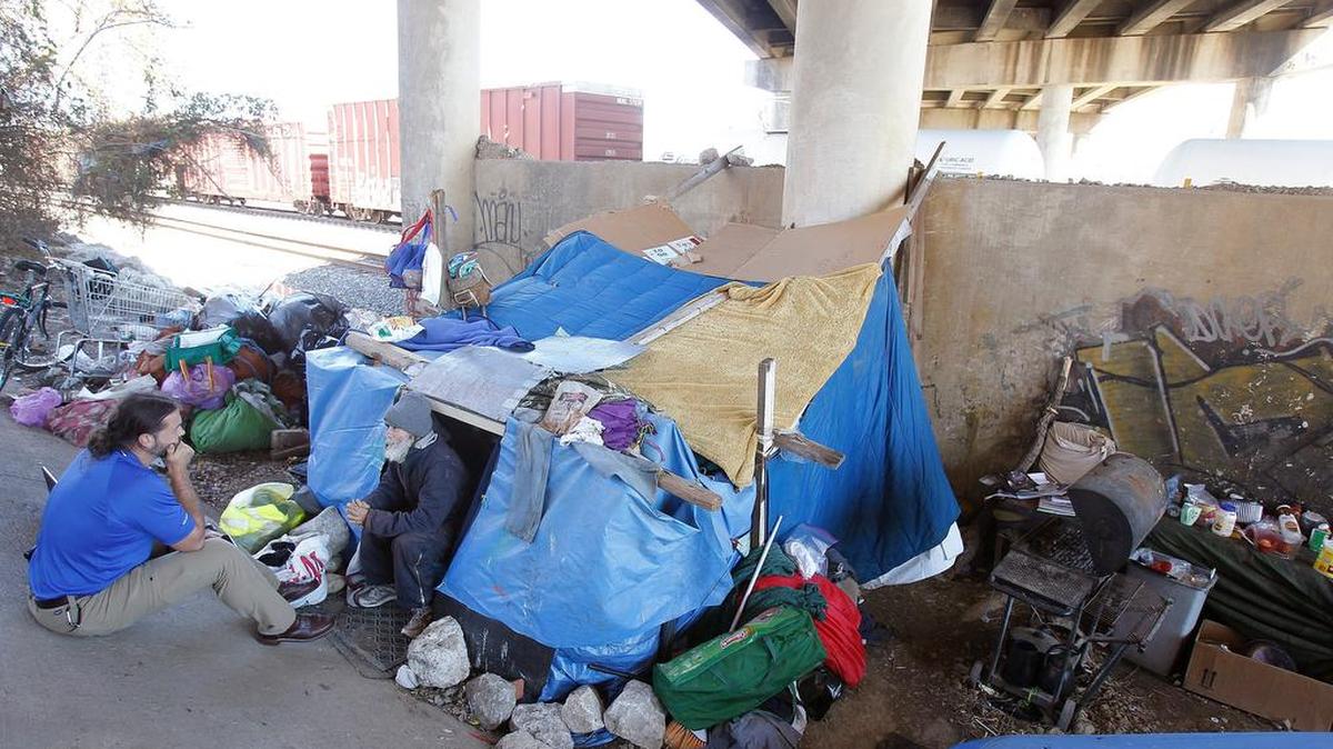 JPS physician assistant Joel Hunt checks on a man living under a bridge in Fort Worth.