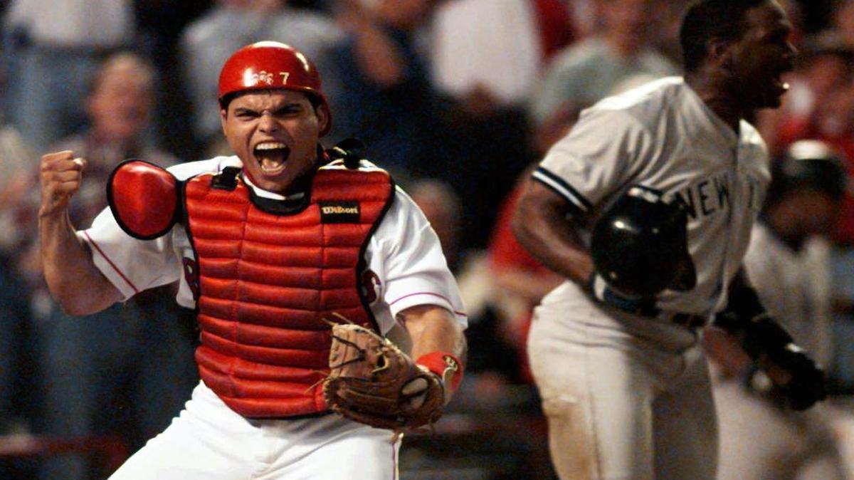 Texas Rangers catcher Ivan Rodriguez reacts after tagging out New York Yankees’ Tim Raines, right, as he tried to score in the fourth inning of Game 3 of the 1996 American League Divisional playoffs in Arlington.